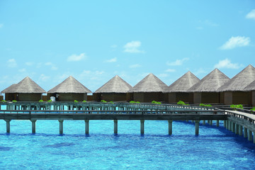 Water villas over ocean background