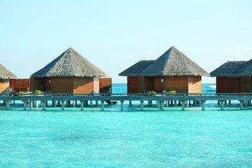 Water villas over ocean background, in resort