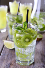 Glasses of cocktails on wooden table, closeup