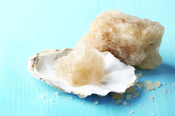 Crust of sea salt from Dead Sea coast, on color wooden background