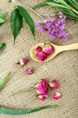 Green herbs and leaves on sackcloth, closeup