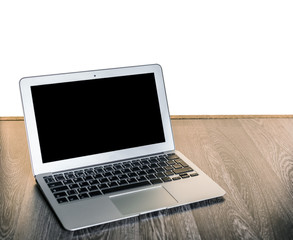 Open laptop on a wooden desk