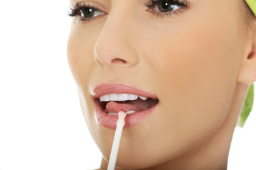 Naklejka premium Beautiful woman applying lipstick.
