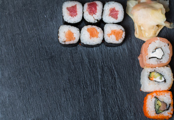 sushi and rolls on black top view