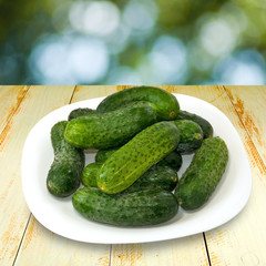 plates with cucumbers on wooden table