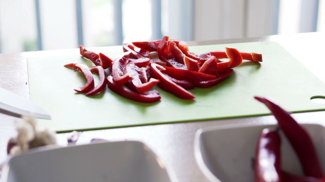 Sliced red pepper on chopping board in kitchen
