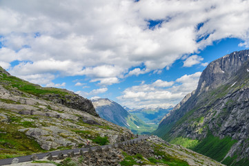 Fototapeta na wymiar Mountain road Trollstigen with view on cloudscape valley