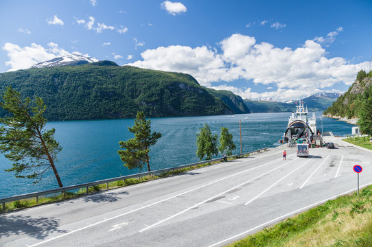 Car loading at small ferry terminal, fjord Norway