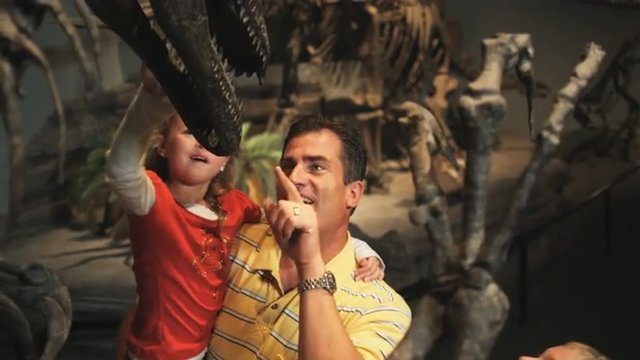 MS Farther with daughter (8-9) and son (10-11) looking at dinosaurs skeleton in natural history museum, Lehi, Utah, USA