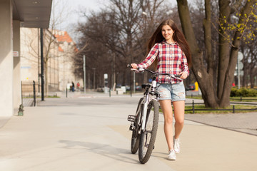 Young beautiful woman on a bicycle