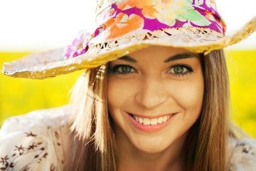 Happy woman in a wicker hat