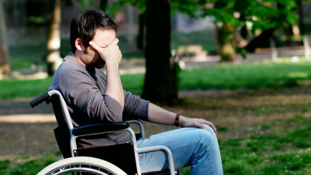 Portrait of a depressed man on a wheelchair