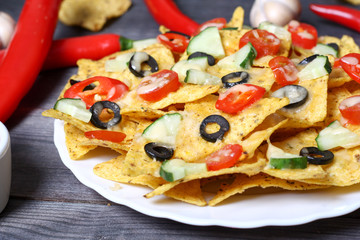 Mexican hot nachos with vegetables and chili