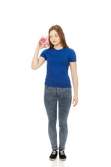 Fototapeta premium Teenage woman holding piggybank.
