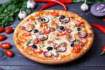 pizza with sausage, olives and chili pepper