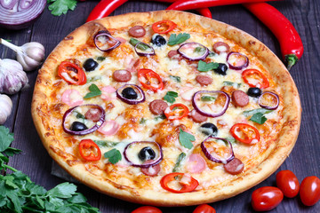 pizza with sausage, olives and chili pepper