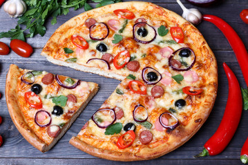 pizza with sausage, olives and chili pepper