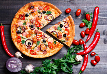 pizza with sausage, olives and chili pepper