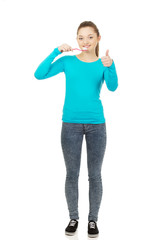 Fototapeta premium Young woman brushing teeth.