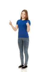 Fototapeta premium Happy female student showing thumbs up.