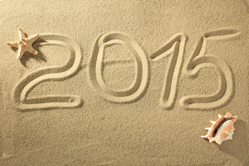 2015 written on the sand of the beach