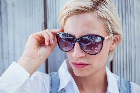 Pretty blonde woman wearing sun glasses
