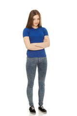 Teenage woman with crossed arms.