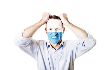 Mature man with San Marino flag on face.