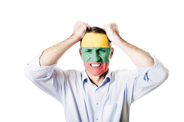 Mature man with Lithuania flag on face.