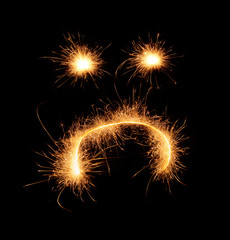 Upset weird sad smiley drawn with sparkles isolated on black