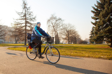 elderly man riding a bicycle