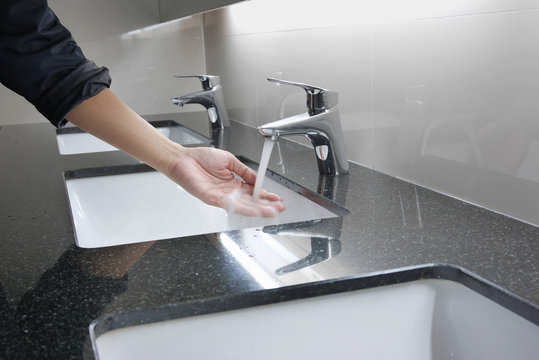 white washbasin and faucet on granite counter with hand washing