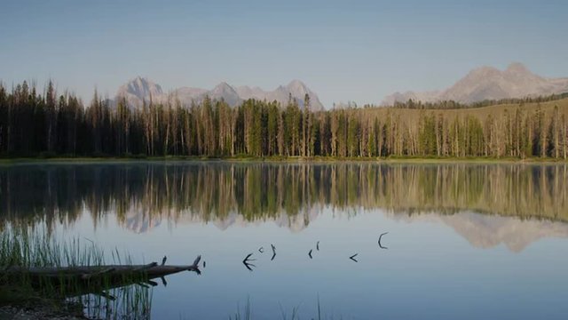 Wide shot scenic view of mountains and calm lake / Redfish Lake, Idaho, United States