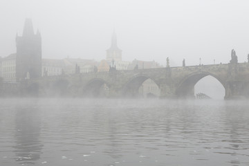 Morning fog over the Charles Bridge in Prague.