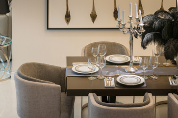 dining table and comfortable chairs in modern home with elegant