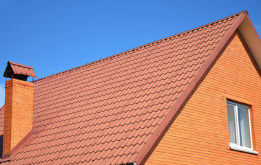 Old faded red metal roof tile blue sky