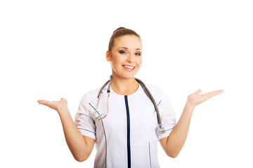 Female doctor presenting copyspace in both hands