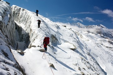 group of climbers on rope on glacier