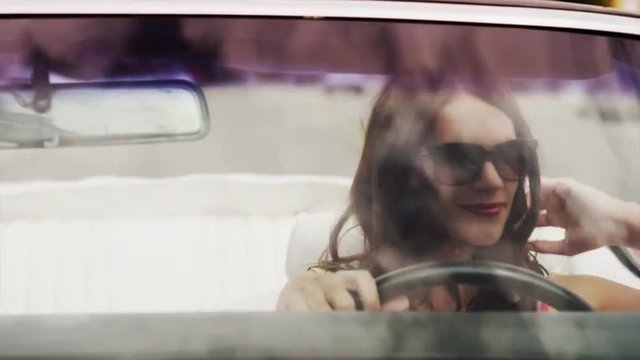 Close up tracking shot of beautiful woman driving convertible car / Pleasant Grove, Utah, United States