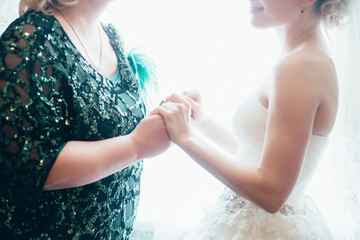 bride with mother wedding hand