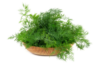 bunch of dill on wooden bowl isolated on white