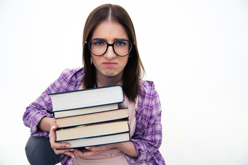 Unhappy young female student with books