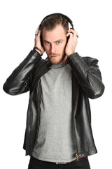 Young attractive DJ wearing headphones and a  leather jacket
