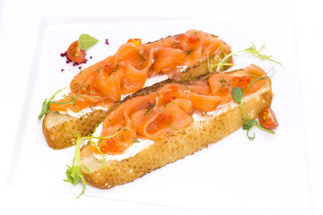 sandwiches with salmon caviar and greens adorned