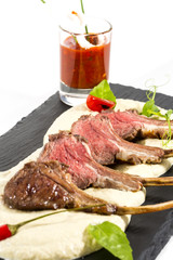 lamb ribs cooked on the grill served on a hot stone