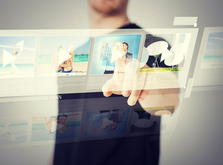 man pressing button on virtual screen