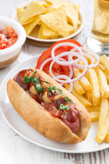 hot dogs with tomatoes, onions and french fries, vertical