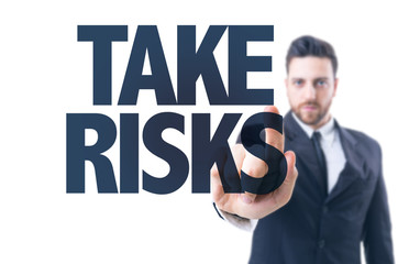 Business man pointing the text: Take Risks