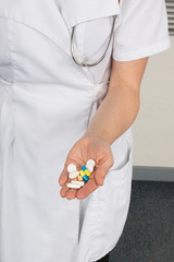 Pills, tablets and drugs heap in doctor hand,
