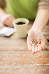 close up of woman hand holding seeds